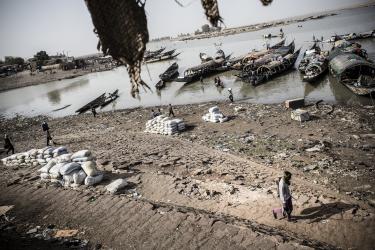 People at water with boats and dry land 