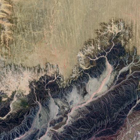 An aerial photograph of a landscape with dry riverbeds